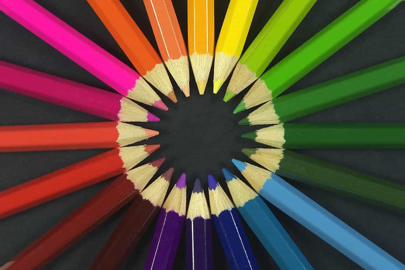 Coloured pencils arranged in a circle with their tips pointing inward