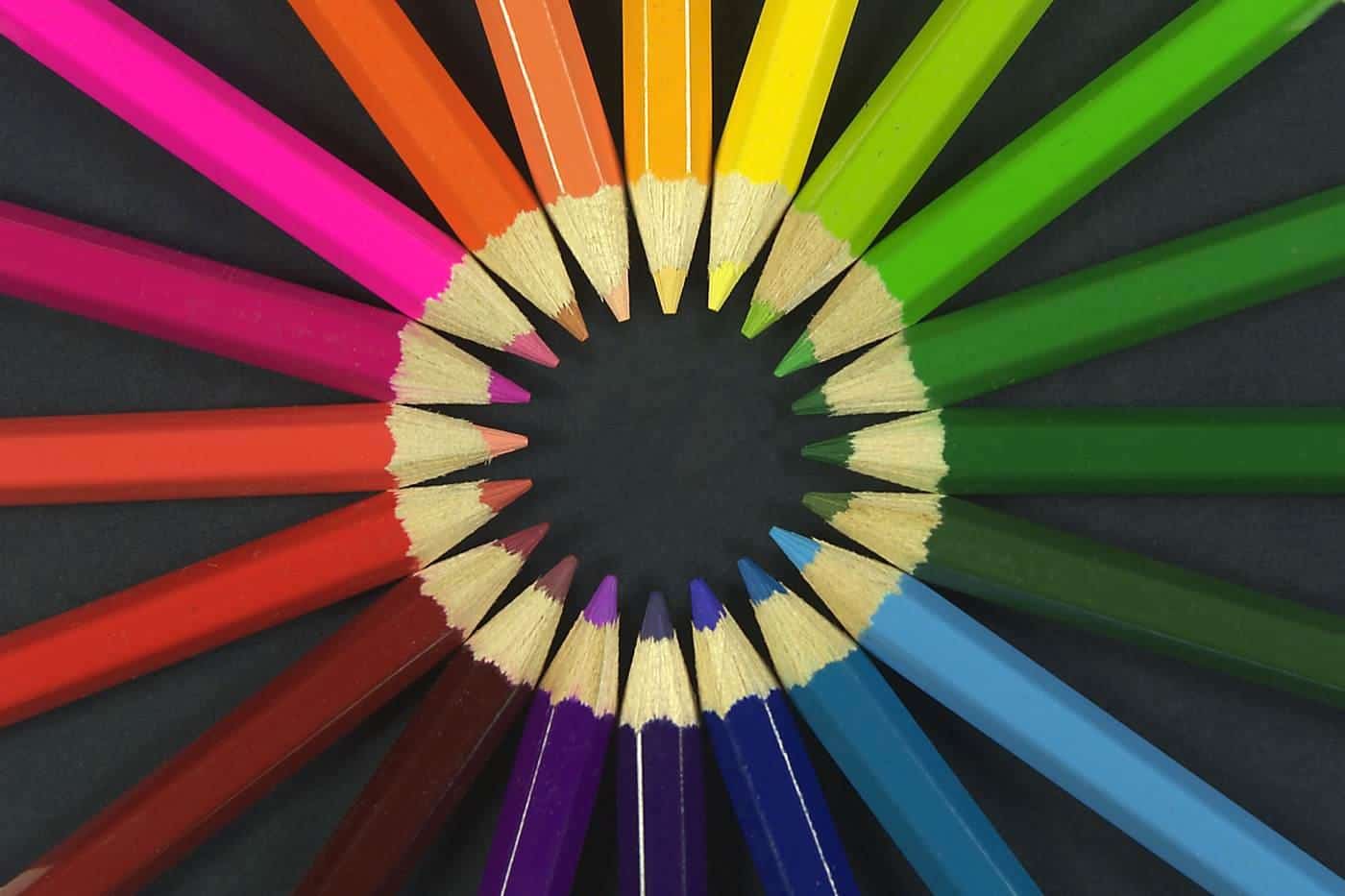 Coloured pencils arranged in a circle with their tips pointing inward